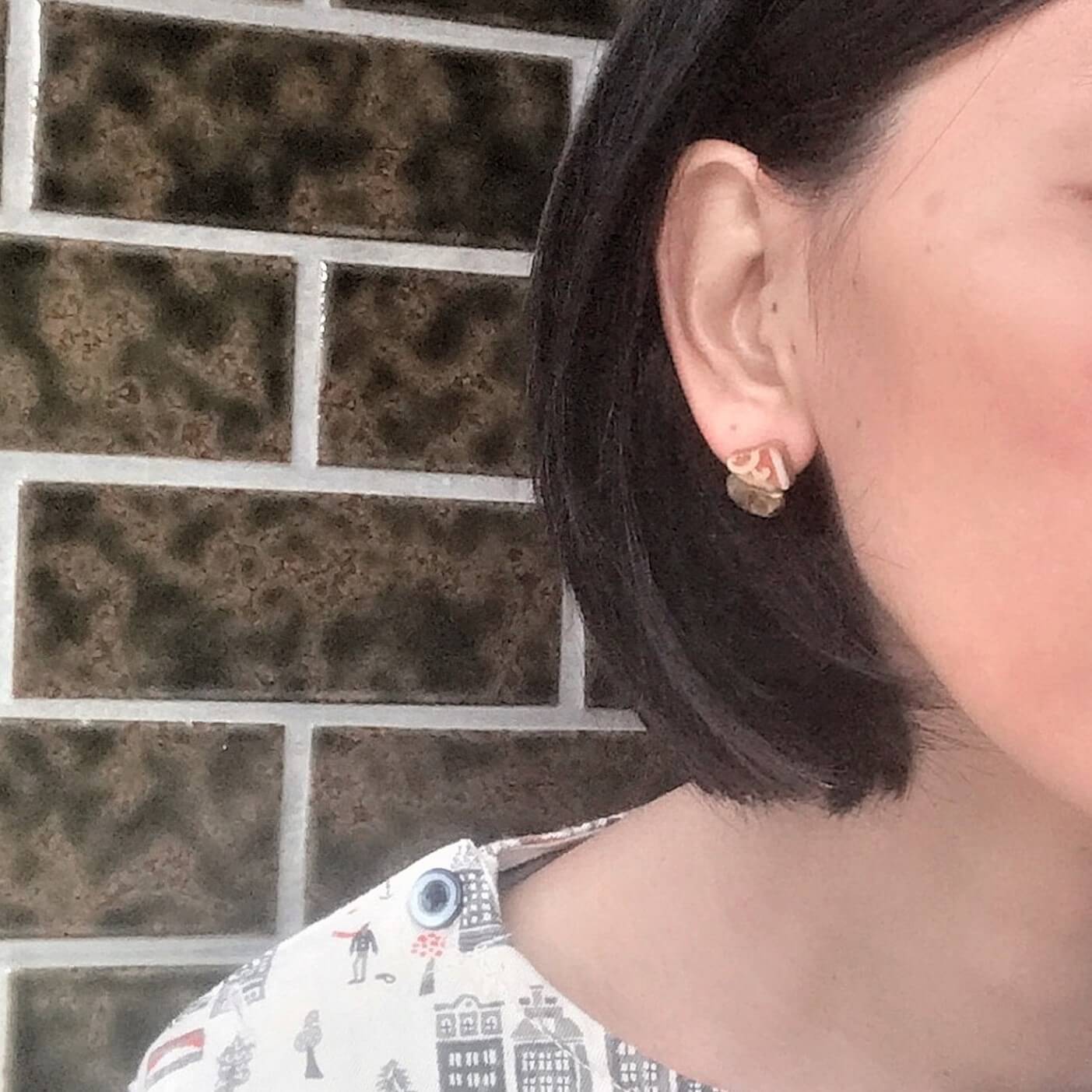 woman wearing Japanese pottery jewelry made with Japanese traditional repairing technique, kintsugi